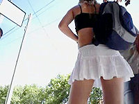 The chippy is wearing such a short white skirt that it is almost impossible not to peek her sneaky upskirt view!